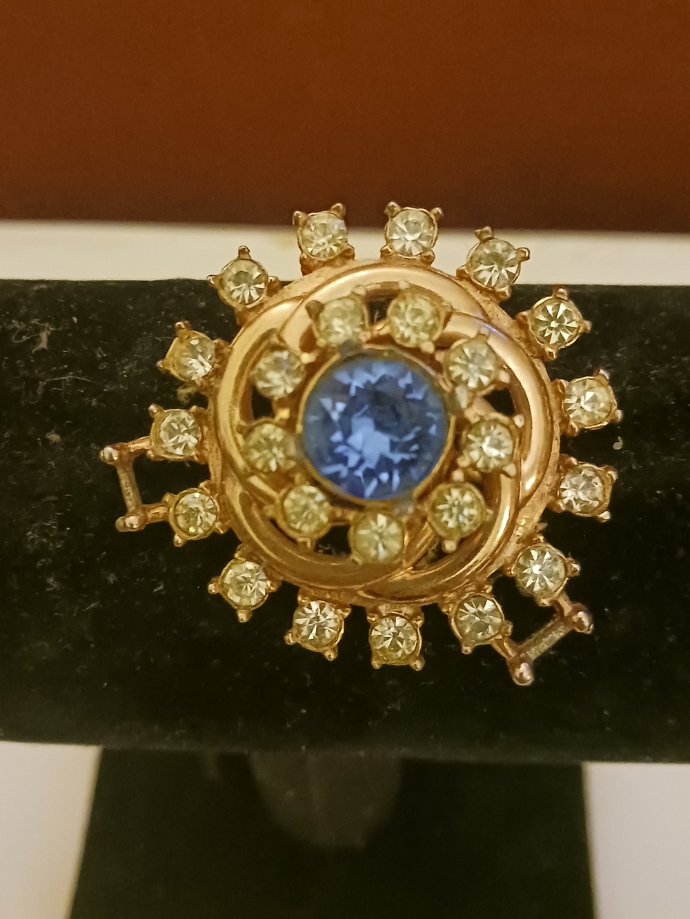 Gold Tone Blue Center Sunburst Brooch with Clear Crystals